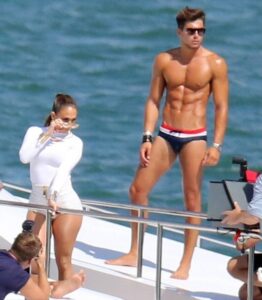 Caught on camera: Jennifer Lopez enjoys a cozy day on a yacht with two young companions!… looking at the outfit we can immediately think of PARTY WH…