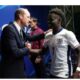 Prince William hugs England goal hero Bukayo saka....